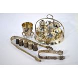 A silver cruet set comprising mustard with blue glass liner, salt and pepper, London 1931, Art