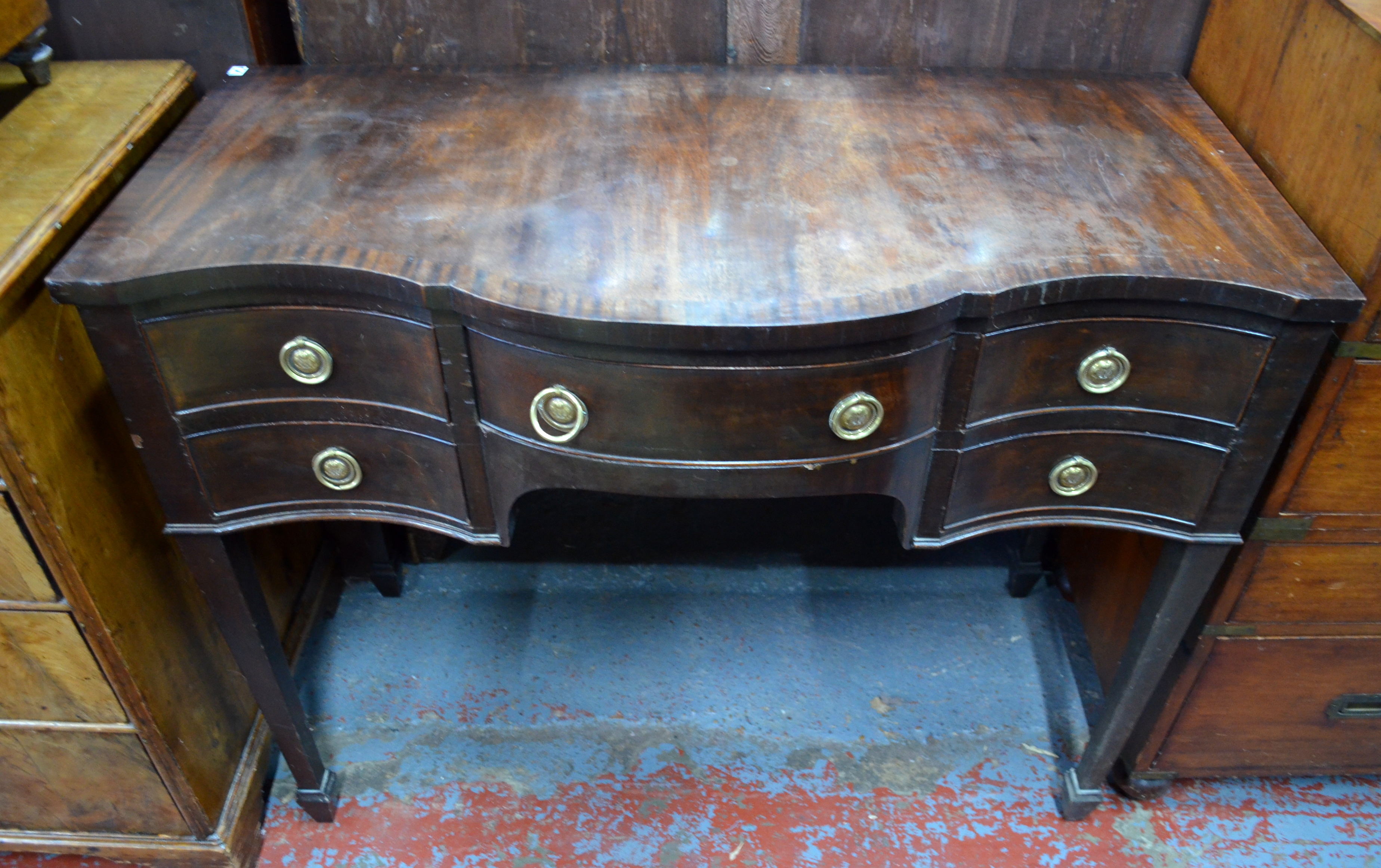 A Victorian style cross-banded mahogany serpentine chest for a canteen of cutlery, raised on