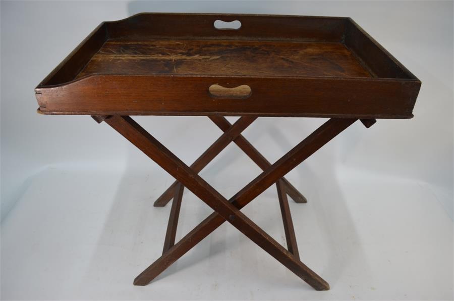 A 19th century oak butler's tray on folding stand