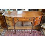 A George III satinwood inlaid mahogany bowfront sideboard with six drawers, raised on six turned and