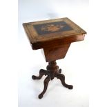 A Victorian walnut work table, the top with inlaid floral urn design hinged to reveal a paper
