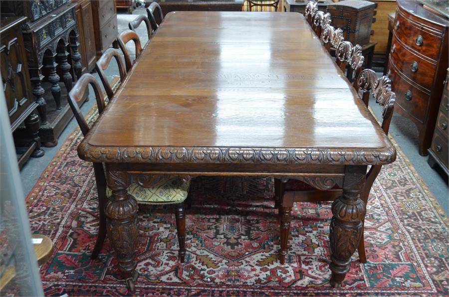 A Victorian oak extending dining table in the Gothic Revival style, the rectangular top with moulded
