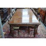 A Victorian oak extending dining table in the Gothic Revival style, the rectangular top with moulded