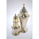 An Art Deco style silver sugar shaker of plain tapering cylindrical form on a plain stepped foot,