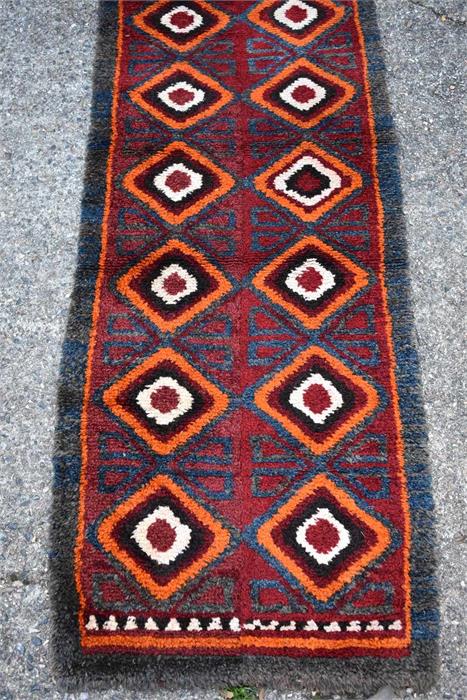 A Julkhyrs rug, circa 1900, the thick wool pile with wine ground and orange diamond design with blue - Image 2 of 3