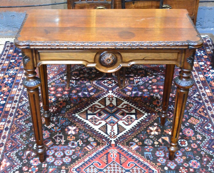 A Victorian oak fold over tea table, the rectangular top with moulded frieze and lobed corners