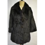 A black glossy mink coat with revere collar, two slits to each side and embossed satin lining, 52 cm