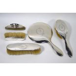 A Sterling five-piece brush set, including hand-mirror and nail-buffer, with wreath engraving