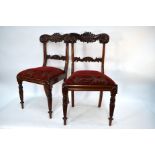 A set of six Regency style mahogany dining chairs with moulded bar backs over fabric seats, raised