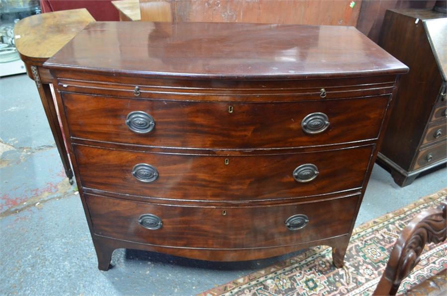 A 19th century bow front mahogany chest with brush slide over three long graduated drawers, raised