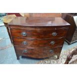 A 19th century bow front mahogany chest with brush slide over three long graduated drawers, raised