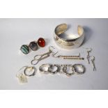 A collection of silver and white metal jewellery including a contemporary hammered silver open