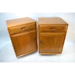 A pair of Ercol elm bedside cabinets on trademark castors, c. 1970's (2)Good condition - couple of