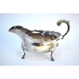 A Victorian sauce boat with scroll handle and shaped rim, on three hoof foot, London 1894, maker