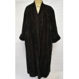 A 1930s black velvet evening coat with cut-out repeating diamond and circle pattern on pink