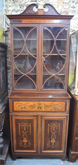 A Sheraton Revival marquetry inlaid satinwood and walnut secretaire bookcase, the broken swaneck