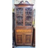 A Sheraton Revival marquetry inlaid satinwood and walnut secretaire bookcase, the broken swaneck