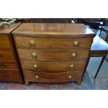 A 19th century bow front chest of four long graduated drawers with lion mask and ring handles,