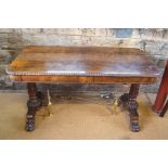 A Victorian figured rosewood library table, the rectangular top with rounded corners and all-round