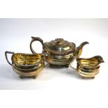A heavy quality silver three-piece tea service in the Regency manner with floral-chased handles,