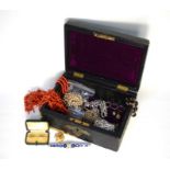 A leather jewel box containing a quantity of antique and vintage jewellery including two rows of