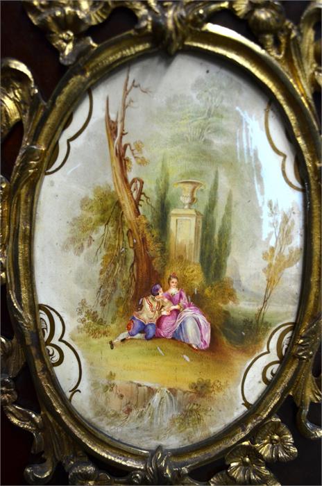 A late 18th/19th century continental ormolu and multiple porcelain plaque mounted, tulipwood and