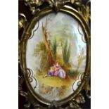 A late 18th/19th century continental ormolu and multiple porcelain plaque mounted, tulipwood and