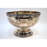 A plated on copper punch-bowl with foliate and scroll cast rim and embossing, on stemmed and moulded