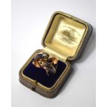 A Continental yellow metal ring formed of two conjoined dolphins with blue enamel decoration and