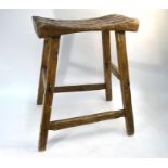 An antique 'style' rustic fruitwood joint stool, the dished plank seat on a stock frame, 43 x 23 x