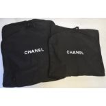 Four Chanel suit carriers contained in a Chanel retail bag with Camellia to front