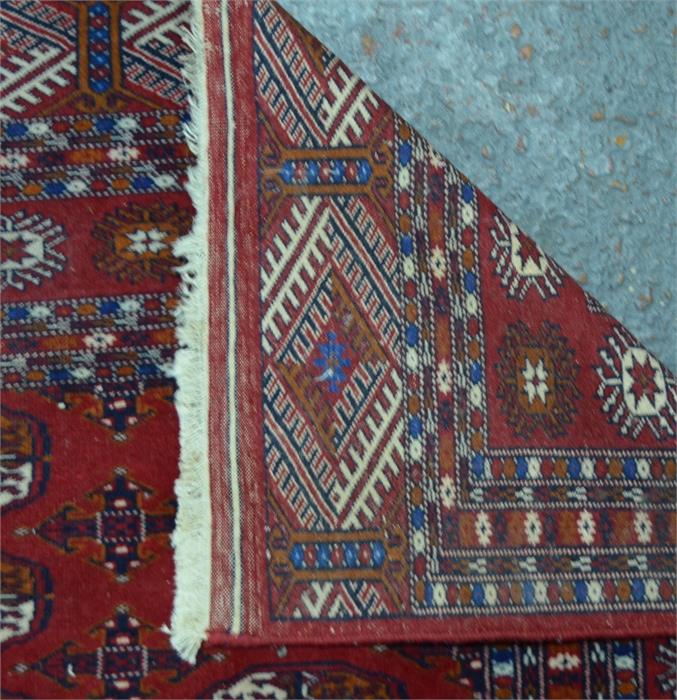 A Turkish design handmade rug, the field of three rows of guls on red ground, 198 cm x 129 cm - Image 2 of 2