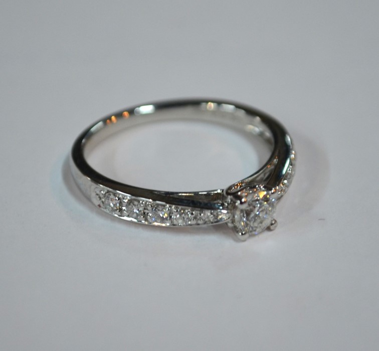 A contemporary 9ct white gold diamond ring, the central circular brilliant cut claw set diamond with - Image 6 of 6