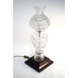 A heavy Irish Kinsale cut glass lamp base raised on a square wooden base to/w a matching lamp shade,