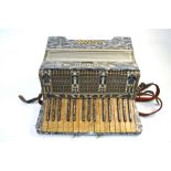 A German Stanelli piano accordion with marbled body and 25 buttons, with case