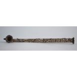 An Indo-Chinese, or other Asian, white metal pipe decorated in high relief with mythological