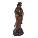 An Asian wood figure of the Bodhisattva, Guanyin or Sho Kannon, wearing a typical high chignon and