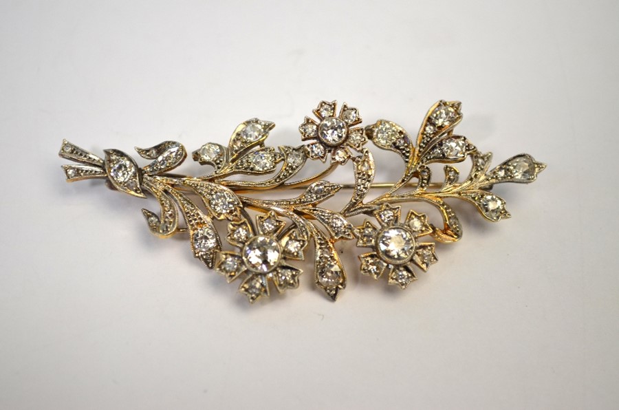 A diamond-set flower spray brooch formed of three flowers and foliage, the largest diamonds approx - Image 2 of 3