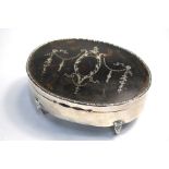 An oval silver, tortoiseshell and piqué-work trinket box with hinged cover and velvet lining, on