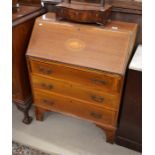A mahogany inlaid bureau, the fall front enclosing a fitted interior over three long drawers