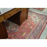 Persian Tabriz carpet with large central geometric medallion on red ground with stylised floral