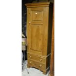 Stained pine single wardrobe with panelled door over two drawers raised on bracket feet