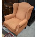 Pair of Georgian style wingback armchairs with striped upholstery and turned mahogany front legs