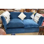 A large knoll sofa with blue velvet upholstery and turned beech finials