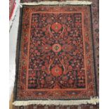 Persian style rug, dark blue ground with floral design 90x65cm