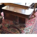 A Regency rosewood folding card table raised on a turned column and concaved quadraform base with