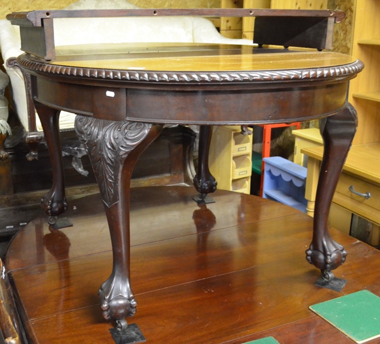 A mahogany extending dining table, the rounded 'pie crust' top with single central leaf raised on