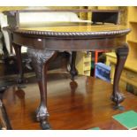 A mahogany extending dining table, the rounded 'pie crust' top with single central leaf raised on