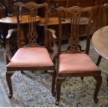 Nine oak Queen Anne style dining chairs with pierced splats and shaped back rails and pad seats (8 x