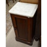 A Victorian mahogany marble top pot cupboard with single panelled door, raised on a plinth base